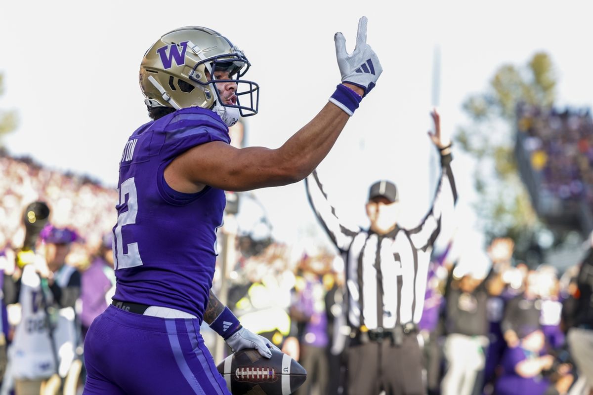 Oct 5, 2024; Seattle, Washington, USA; Washington Huskies wide receiver Denzel Boston (12) celebrates after catching a touchdown pass against the Michigan Wolverines during the first quarter at Alaska Airlines Field at Husky Stadium. Mandatory Credit: Joe Nicholson-Imagn Images