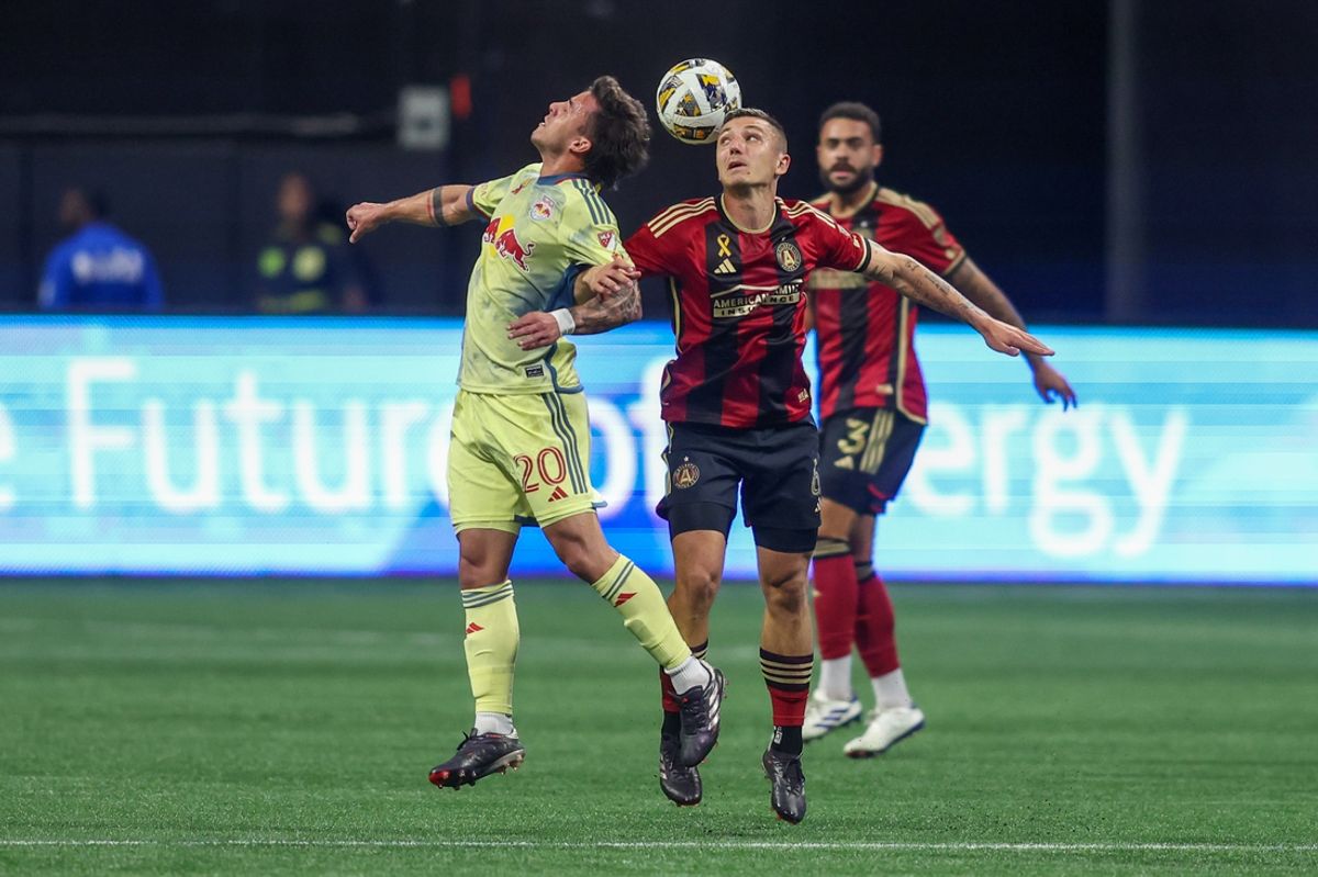 Oct 5, 2024; Atlanta, Georgia, USA; New York Red Bulls midfielder Felipe Carballo (20) and Atlanta United midfielder Bartosz Slisz (6) go up for a header in the first half at Mercedes-Benz Stadium. Mandatory Credit: Brett Davis-Imagn Images