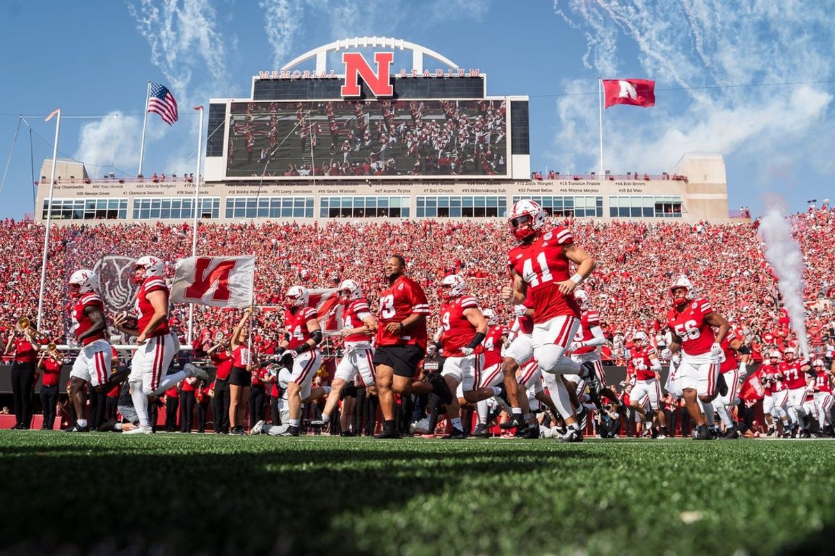 Oct 5, 2024; Lincoln, Nebraska, USA; Nebraska Cornhuskers former defensive lineman Ndamukong Suh (93) runs onto the field with the team before a game against the Rutgers Scarlet Knights at Memorial Stadium. Mandatory Credit: Dylan Widger-Imagn Images