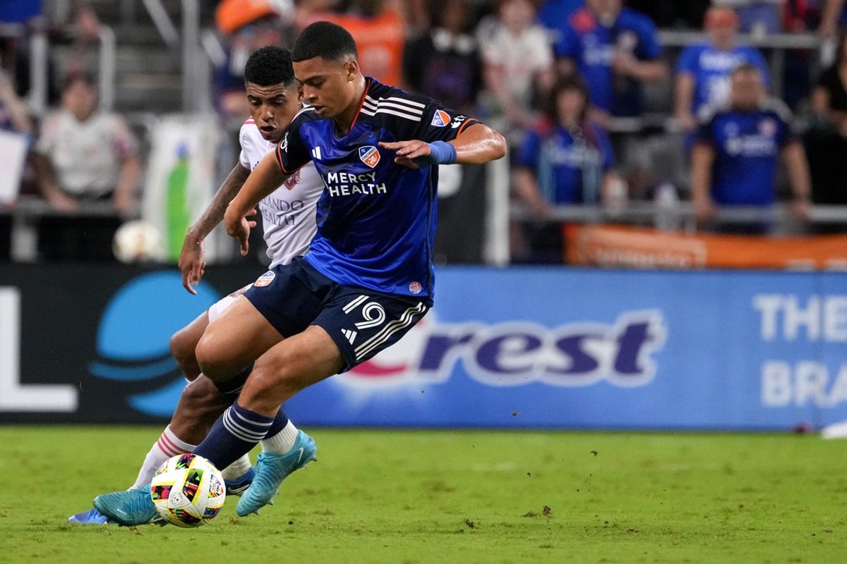 Oct 5, 2024; Cincinnati, Ohio, USA; FC Cincinnati forward Kevin Kelsy (19) changes direction as Orlando City SC midfielder Wilder Cartagena (16) defends during the first half at TQL Stadium. Mandatory Credit: Kareem Elgazzar-Imagn Images