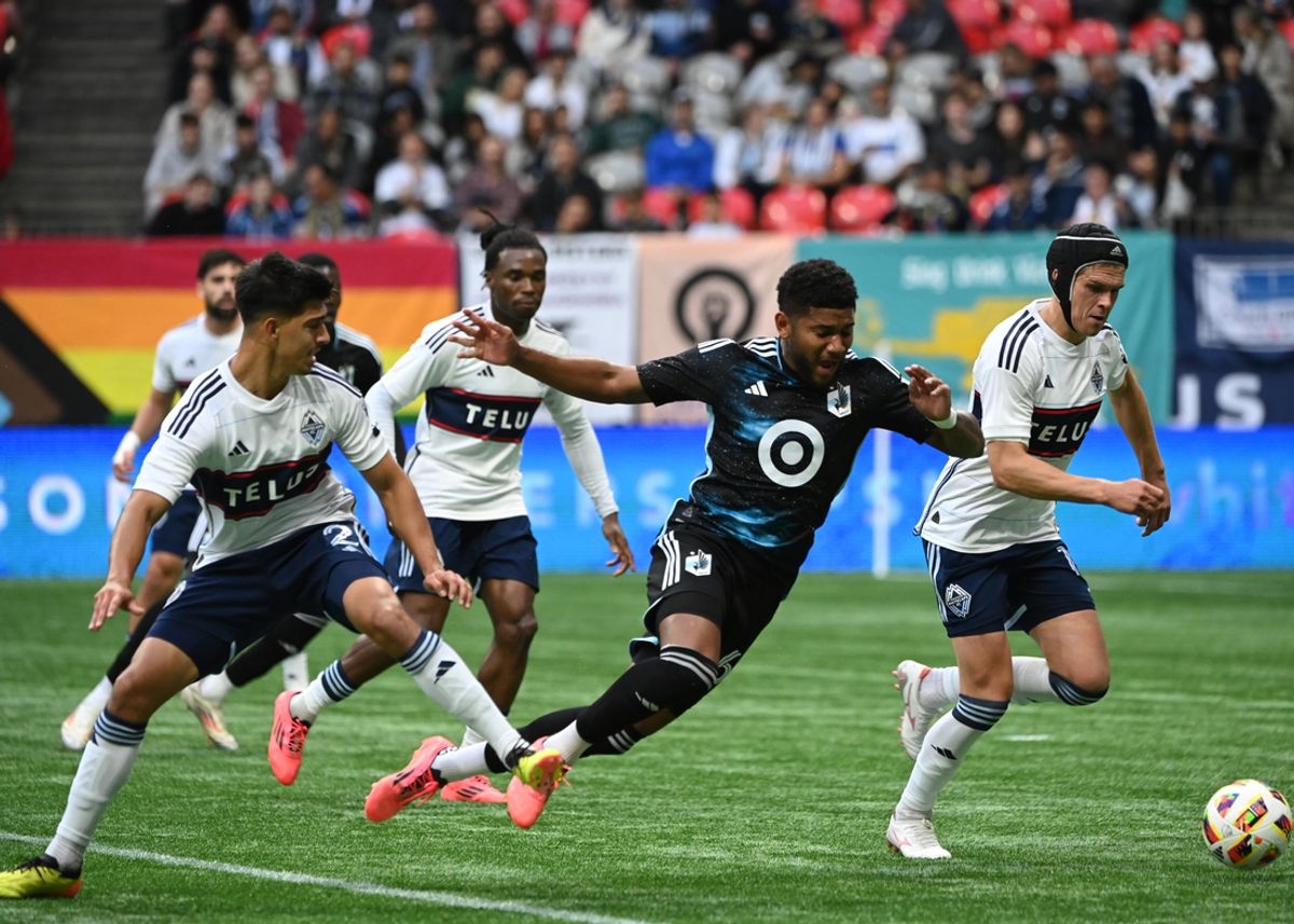 Oct 5, 2024; Vancouver, British Columbia, CAN; Vancouver Whitecaps FC defender Mathias Laborda (2) trips Minnesota United midfielder Carlos Harvey (67) for a penalty kick during the first half at BC Place. Mandatory Credit: Simon Fearn-Imagn Images