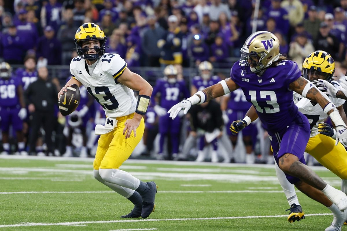 Oct 5, 2024; Seattle, Washington, USA; Michigan Wolverines quarterback Jack Tuttle (13) looks to pass against the Washington Huskies during the third quarter at Alaska Airlines Field at Husky Stadium. Mandatory Credit: Joe Nicholson-Imagn Images