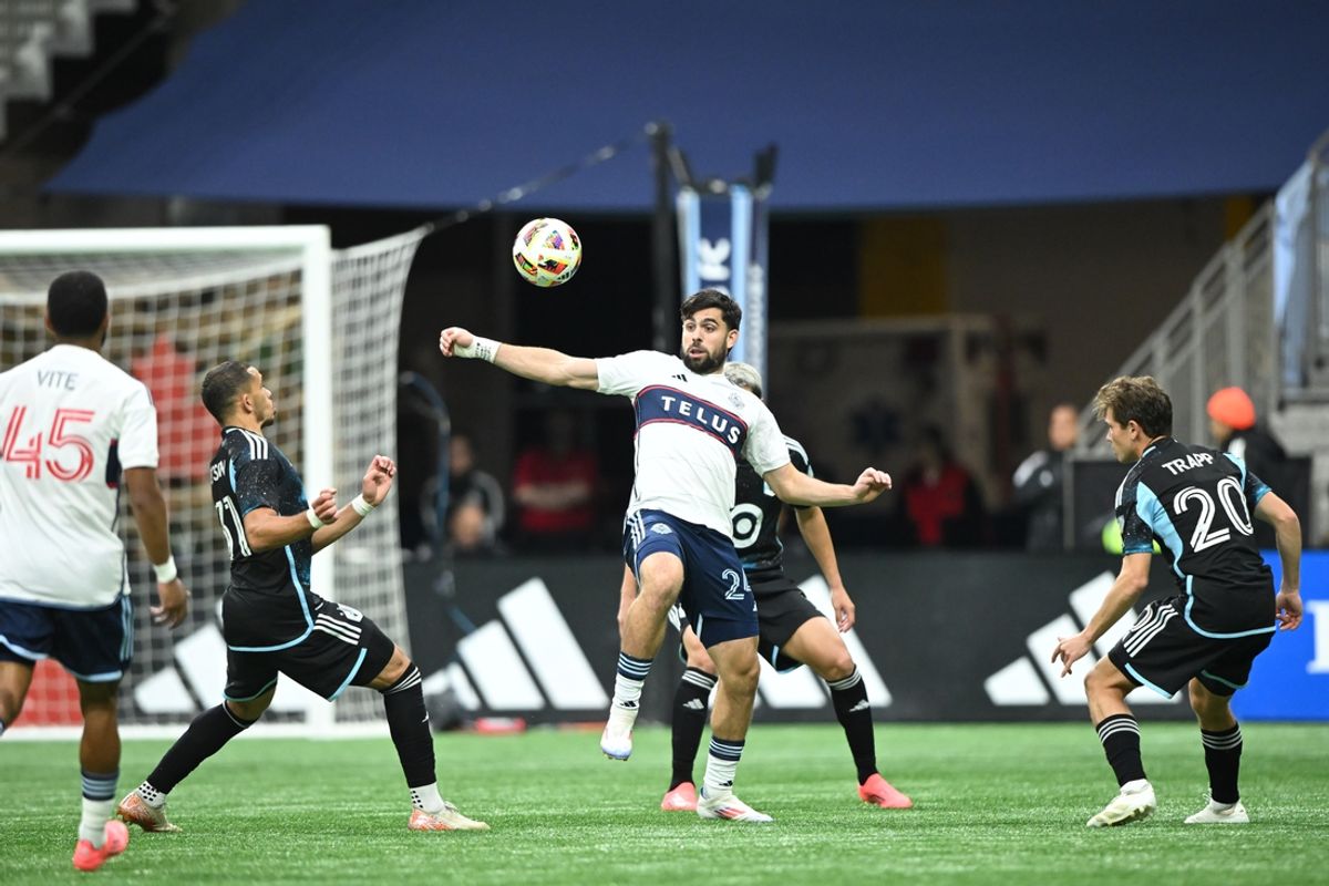 Oct 5, 2024; Vancouver, British Columbia, CAN;  Vancouver Whitecaps FC forward Brian White (24) reaches for the ball against Minnesota United midfielder Hassani Dotson (31) during the second half at BC Place. Mandatory Credit: Anne-Marie Sorvin-Imagn Images