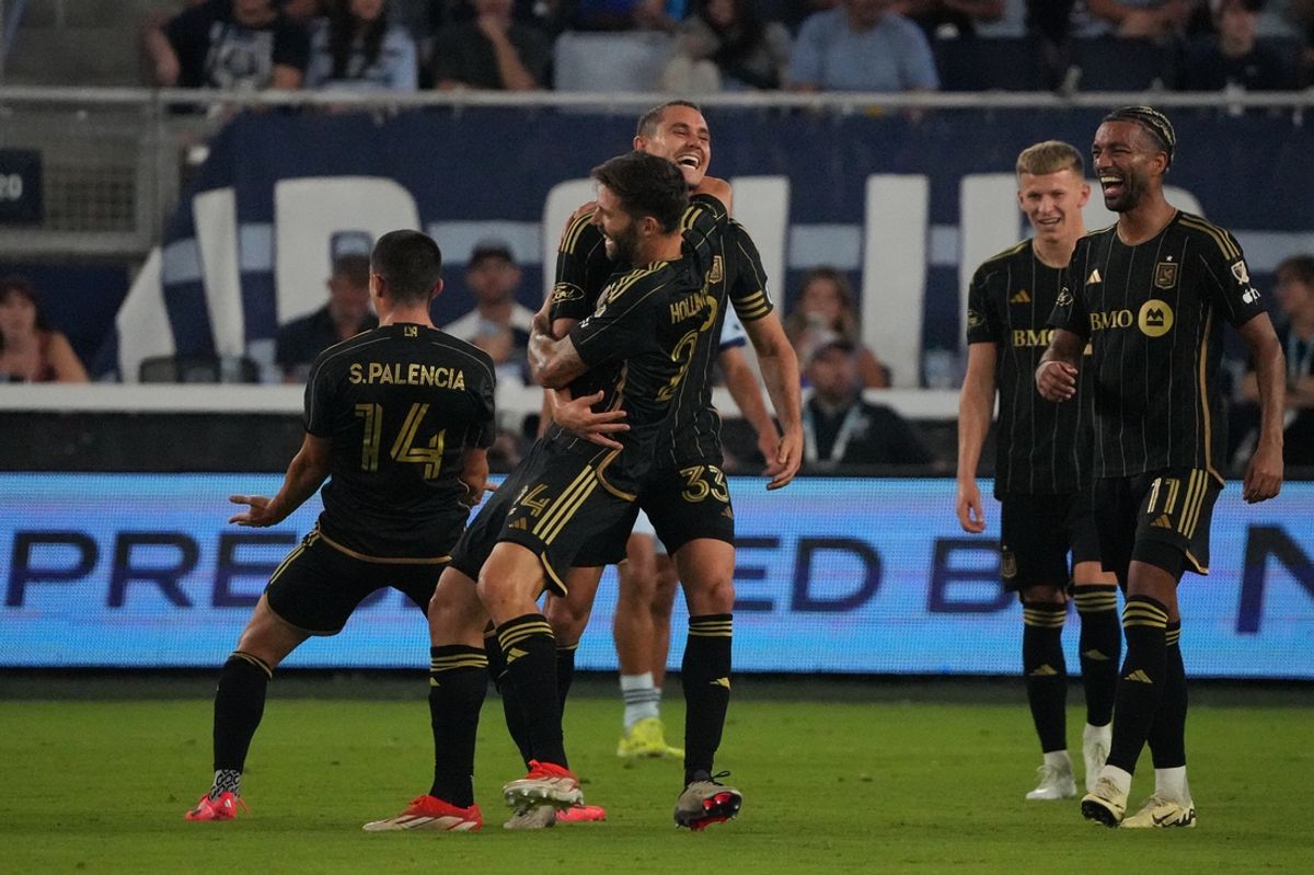 Oct 5, 2024; Kansas City, Kansas, USA; LAFC defender Aaron Long (33) celebrates a goal with midfielder Ryan Hollingshead (24)  in the second half at Children's Mercy Park. Mandatory Credit: Denny Medley-Imagn Images