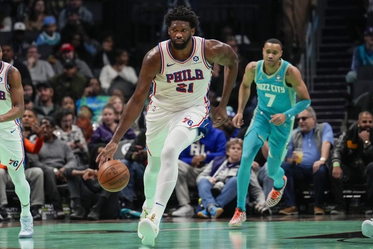 Dec 16, 2023; Charlotte, North Carolina, USA;Philadelphia 76ers center Joel Embiid (21) handles the ball against the Charlotte Hornets during the first quarter at Spectrum Center.