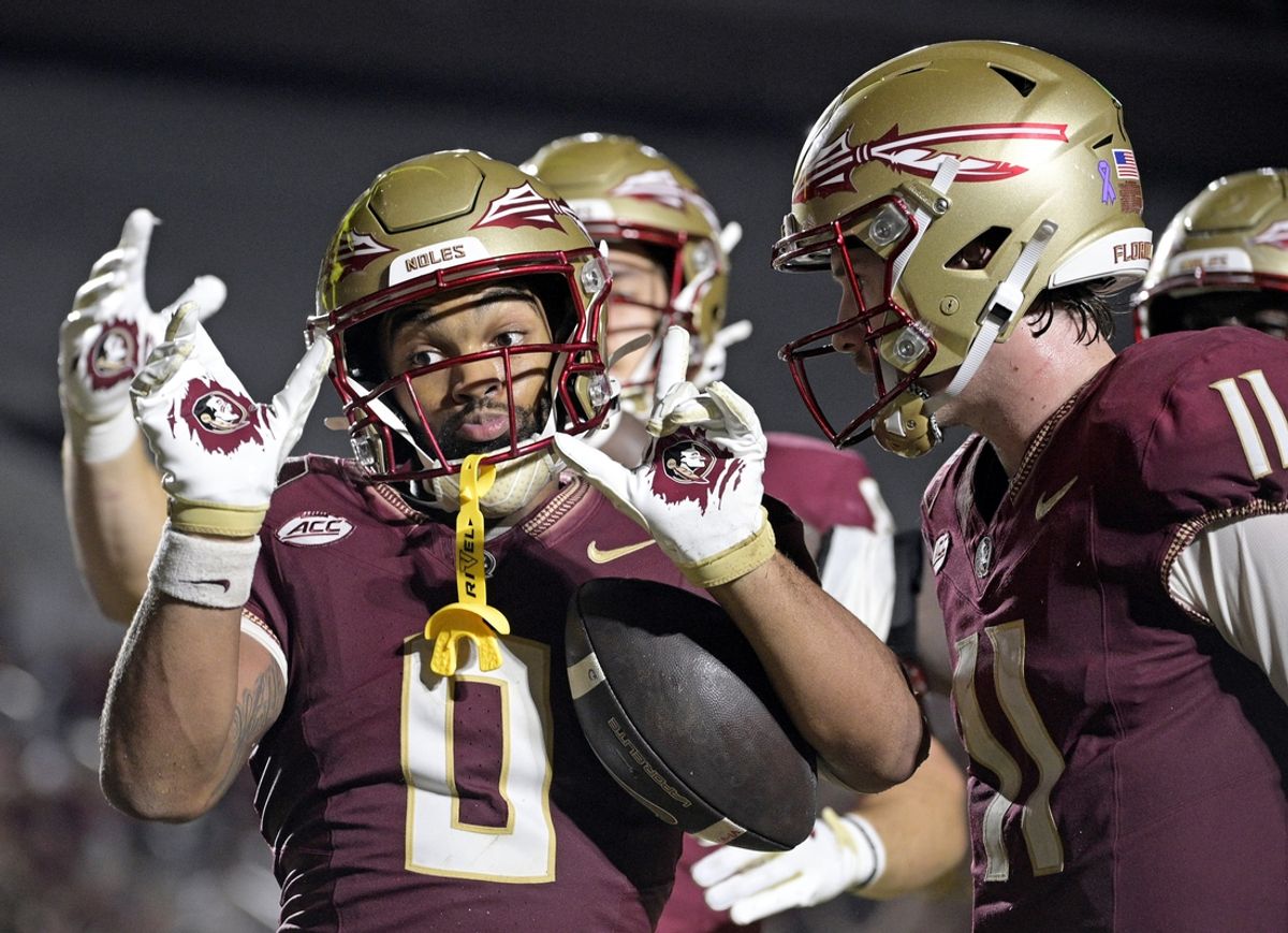 Oct 5, 2024; Tallahassee, Florida, USA; Florida State Seminoles wide receiver Ja'Khi Douglas (0) celebrates with quarterback Brock Glenn (11) after a touchdown against the Clemson Tigers during the second half at Doak S. Campbell Stadium. Mandatory Credit: Melina Myers-Imagn Images