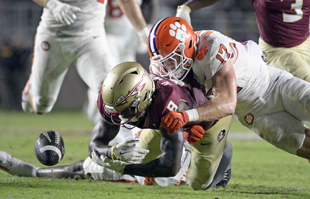 Oct 5, 2024; Tallahassee, Florida, USA; Clemson Tigers linebacker Wade Woodaz (17) forces a fumble by Florida State Seminoles wide receiver Hykeem Williams (8) during the second half at Doak S. Campbell Stadium. Mandatory Credit: Melina Myers-Imagn Images