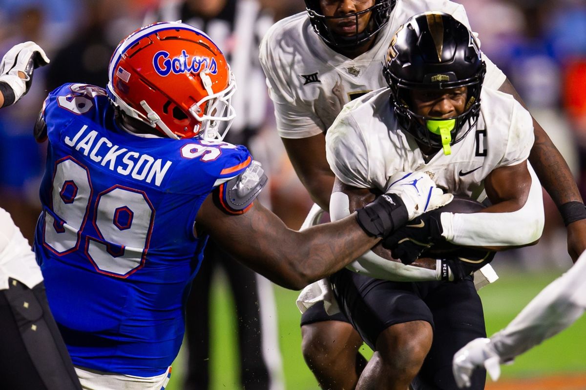 Florida Gators defensive lineman Cam Jackson (99) gets a hand on UCF Knights running back RJ Harvey (7) during the second half at Ben Hill Griffin Stadium in Gainesville, FL on Saturday, October 5, 2024. [Doug Engle/Gainesville Sun]