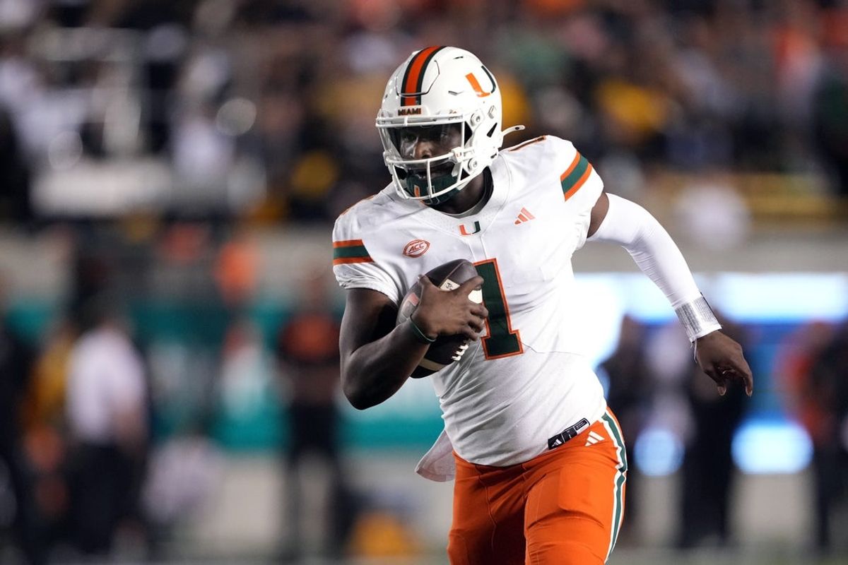 Oct 5, 2024; Berkeley, California, USA; Miami Hurricanes quarterback Cam Ward (1) rushes for a touchdown /across the/ during the fourth quarter at California Memorial Stadium. Mandatory Credit: Darren Yamashita-Imagn Images