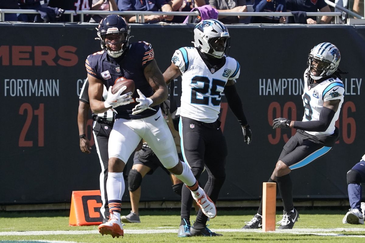 Oct 6, 2024; Chicago, Illinois, USA; Chicago Bears wide receiver DJ Moore (2) catches a touchdown pass as Carolina Panthers safety Xavier Woods (25) defends him during the first half at Soldier Field. Mandatory Credit: David Banks-Imagn Images