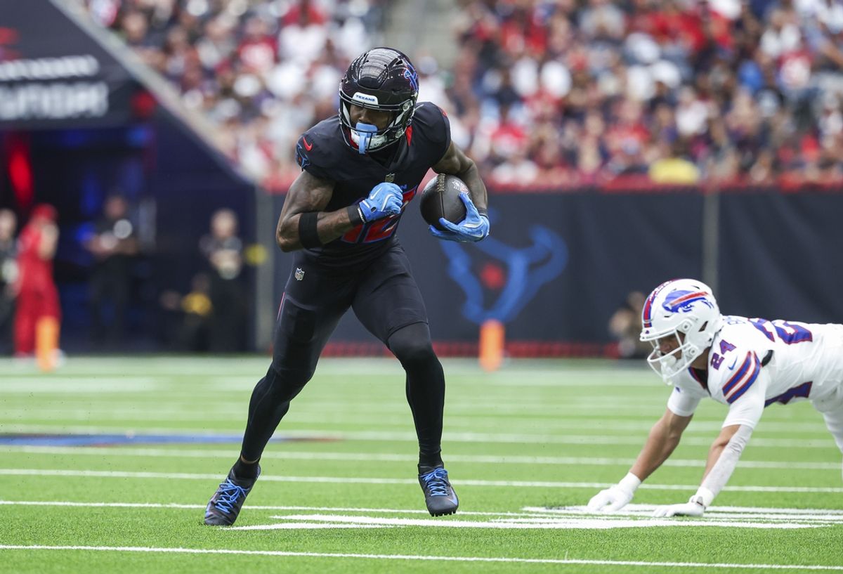 Oct 6, 2024; Houston, Texas, USA; Houston Texans wide receiver Nico Collins (12) runs with the ball after a reception during the first quarter against the Buffalo Bills at NRG Stadium. Mandatory Credit: Troy Taormina-Imagn Images