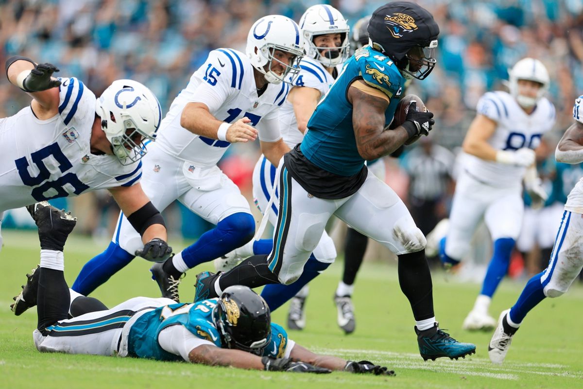 Jacksonville Jaguars defensive end Josh Hines-Allen (41) picks up a fumble during the second quarter of an NFL football matchup Sunday, Oct. 6, 2024 at EverBank Stadium in Jacksonville, Fla. [Corey Perrine/Florida Times-Union]