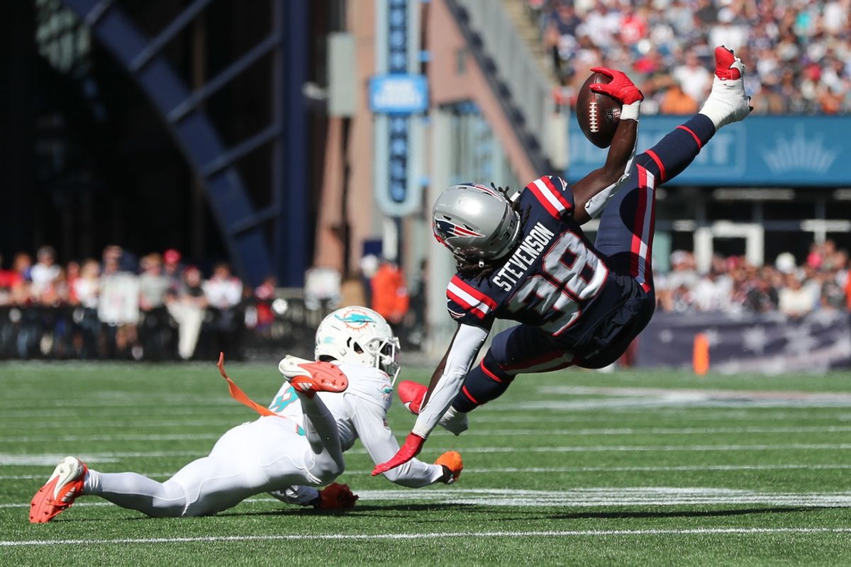 Oct 6, 2024; Foxborough, Massachusetts, USA; Miami Dolphins cornerback Kader Kohou (4) tackles New England Patriots running back Rhamondre Stevenson (38) during the first half at Gillette Stadium. Mandatory Credit: Paul Rutherford-Imagn Images