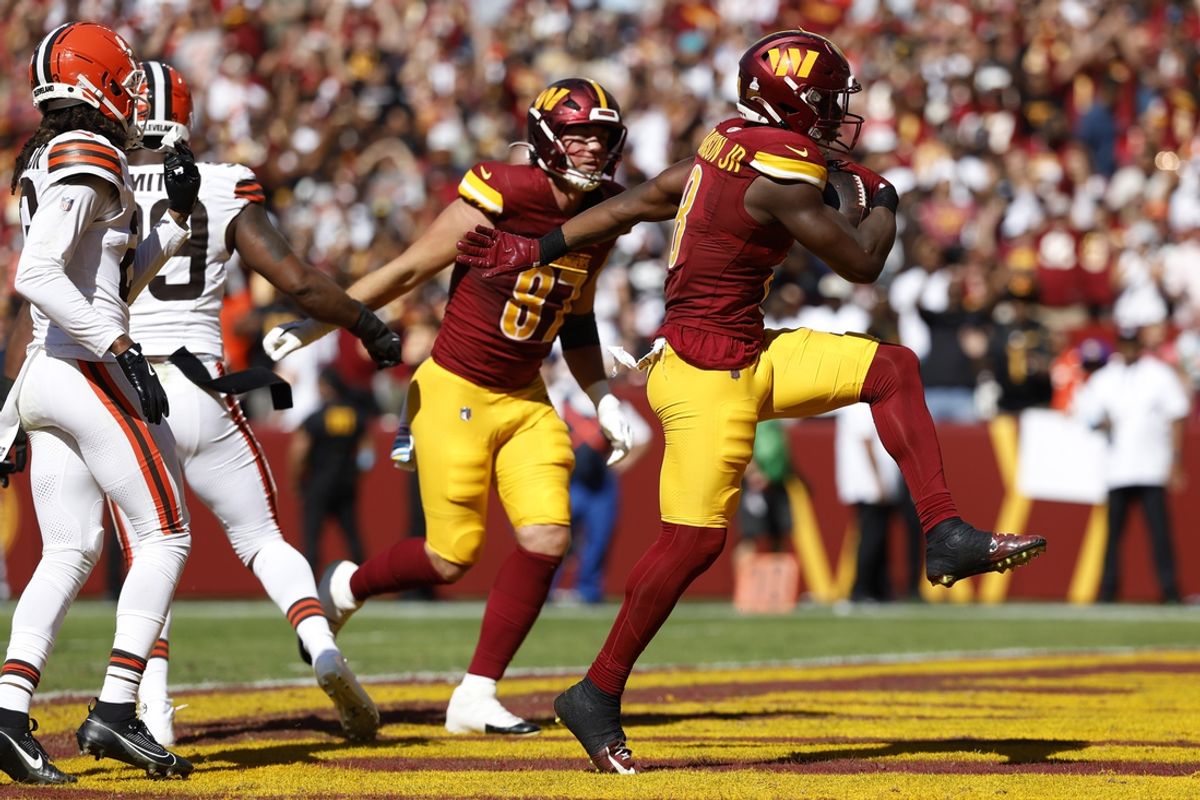 Oct 6, 2024; Landover, Maryland, USA; Washington Commanders running back Brian Robinson Jr. (8) celebrates after scoring a touchdown against the Cleveland Browns during the second quarter at NorthWest Stadium. Mandatory Credit: Geoff Burke-Imagn Images