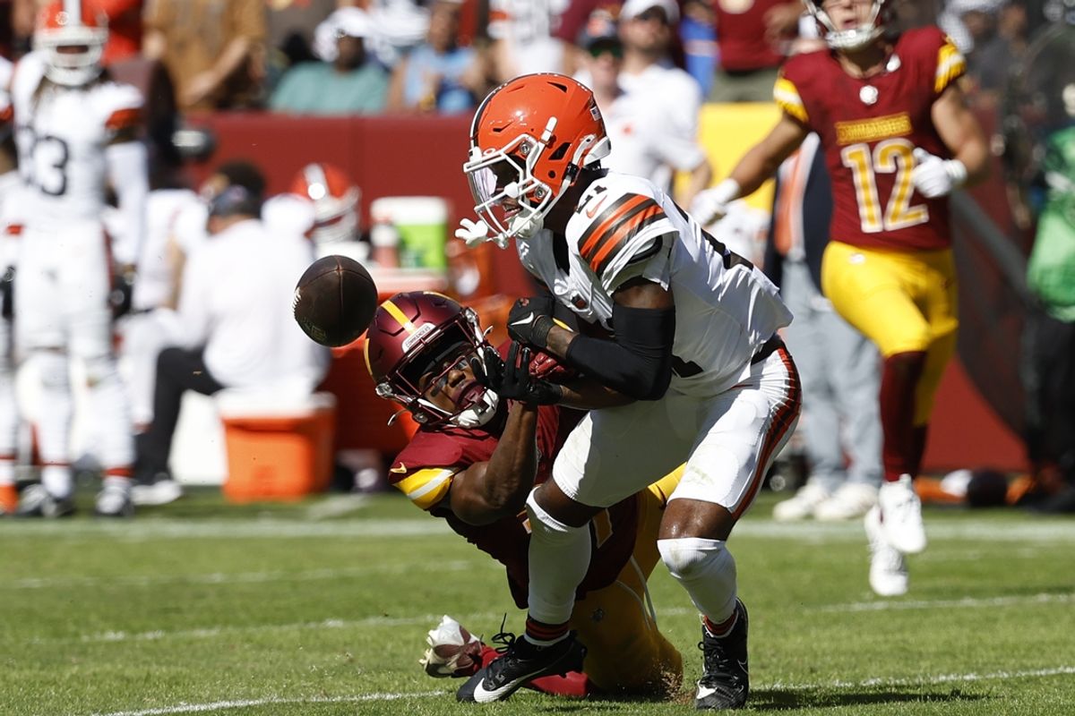 Oct 6, 2024; Landover, Maryland, USA; Cleveland Browns cornerback Denzel Ward (21) breaks up a pass intended for Washington Commanders wide receiver Terry McLaurin (17) during the second quarter at NorthWest Stadium. Mandatory Credit: Geoff Burke-Imagn Images