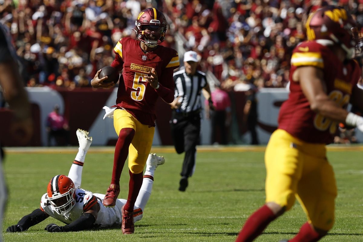 Oct 6, 2024; Landover, Maryland, USA; Washington Commanders quarterback Jayden Daniels (5) runs with the ball past Cleveland Browns defensive end Ogbo Okoronkwo (54) during the second quarter at NorthWest Stadium. Mandatory Credit: Geoff Burke-Imagn Images