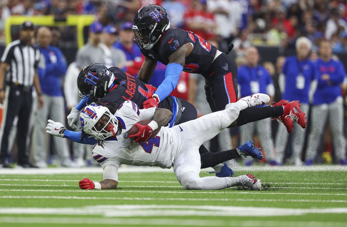 Oct 6, 2024; Houston, Texas, USA; Houston Texans cornerback Kamari Lassiter (4) makes a hit on Buffalo Bills running back James Cook (4) on a play during the second quarter at NRG Stadium. Mandatory Credit: Troy Taormina-Imagn Images