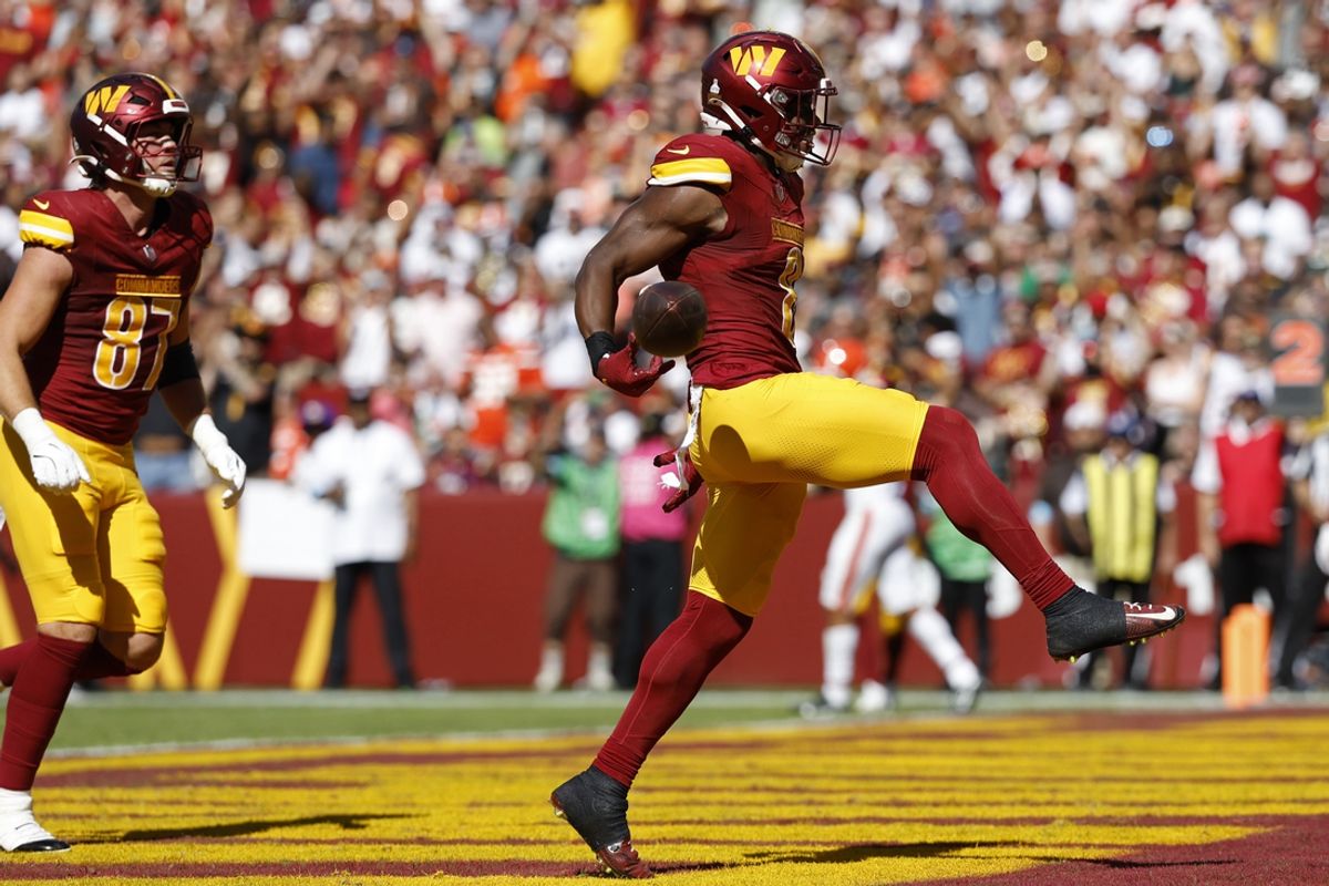 Oct 6, 2024; Landover, Maryland, USA; Washington Commanders running back Brian Robinson Jr. (8) celebrates after scoring a touchdown against the Cleveland Browns during the second quarter at NorthWest Stadium. Mandatory Credit: Geoff Burke-Imagn Images