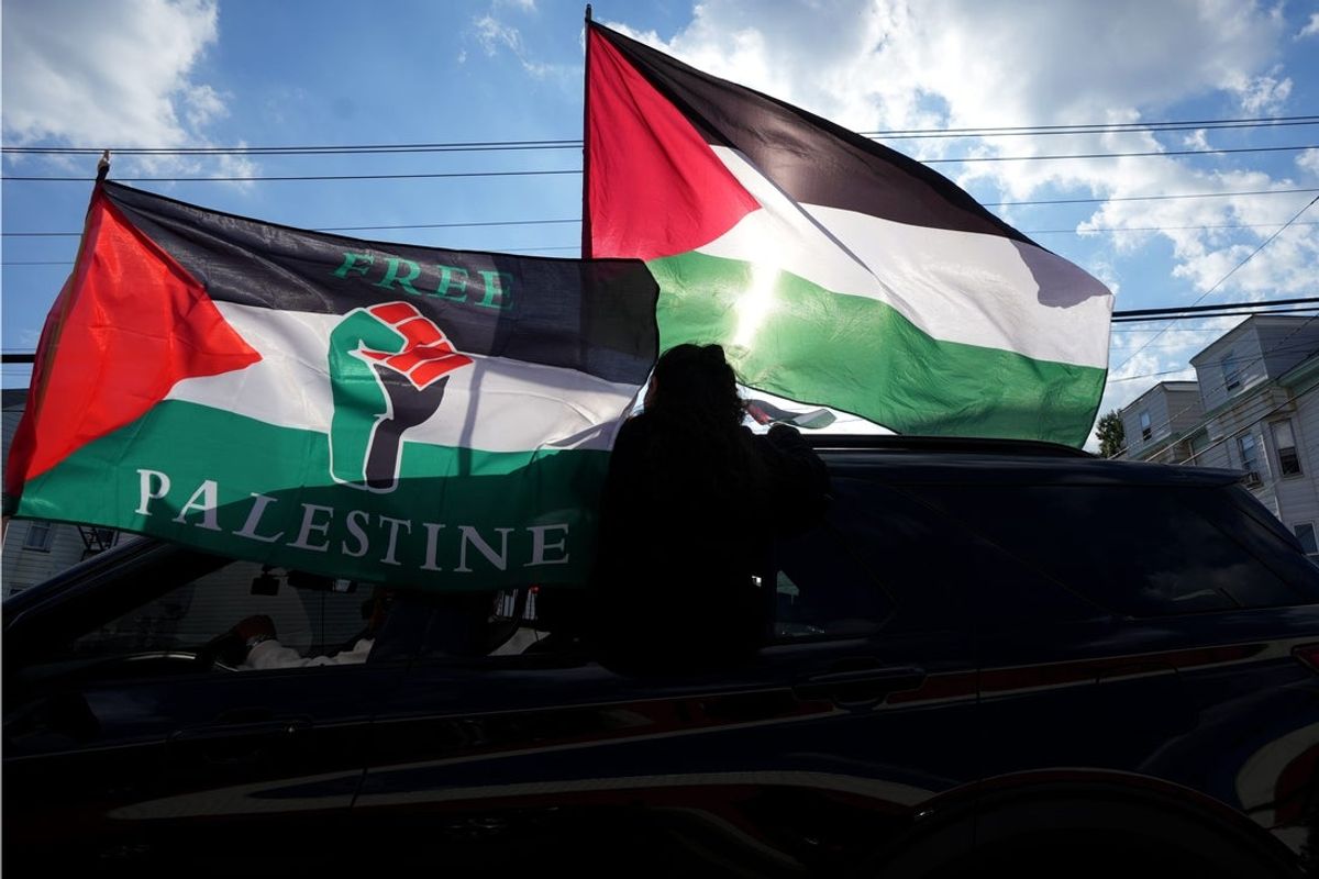 Flags are backlit during the United for Palestine Rally & March in Paterson Sunday, October 6, 2024.