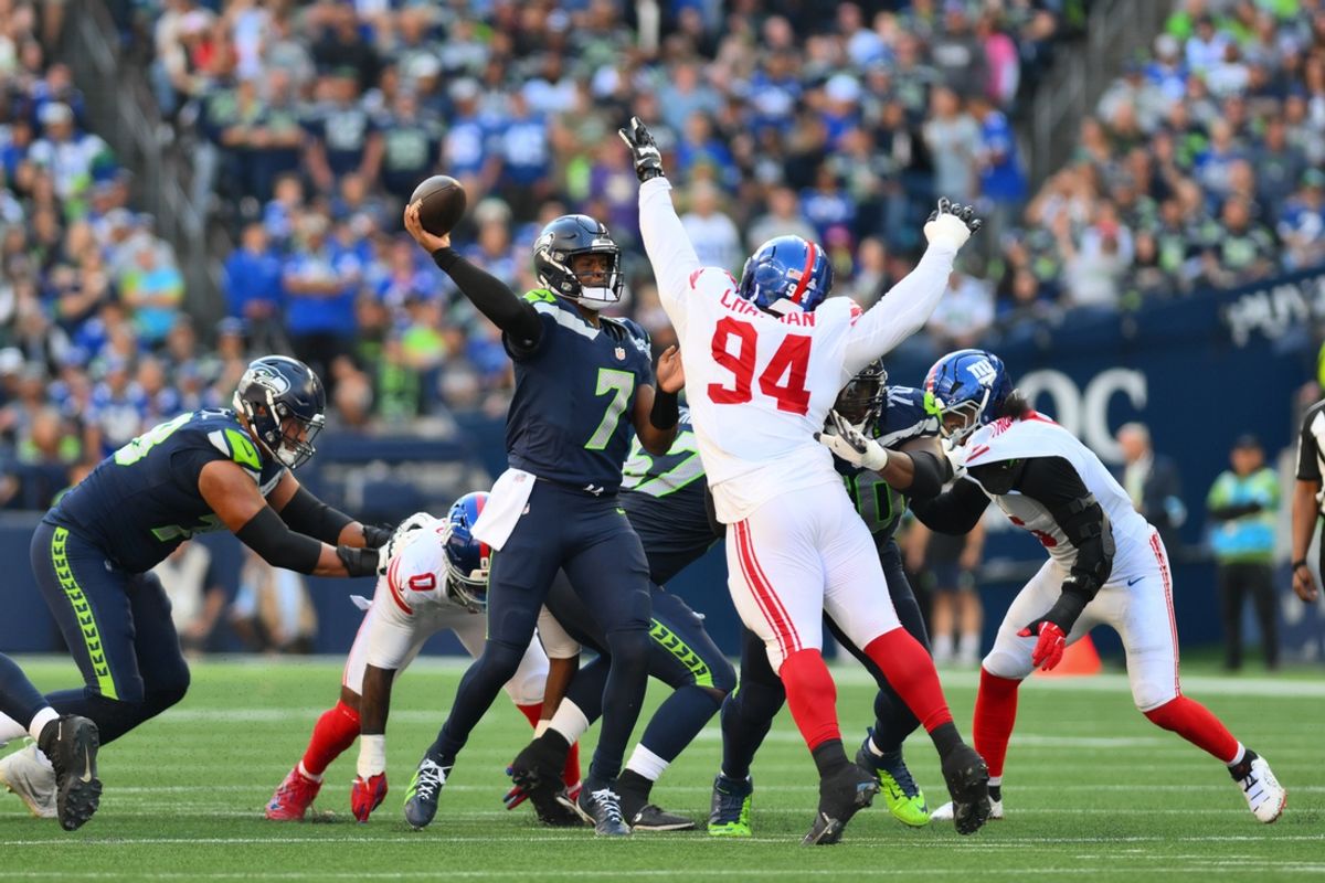 Oct 6, 2024; Seattle, Washington, USA; Seattle Seahawks quarterback Geno Smith (7) passes the ball while defended by New York Giants defensive tackle Elijah Chatman (94) during the second half at Lumen Field. Mandatory Credit: Steven Bisig-Imagn Images
