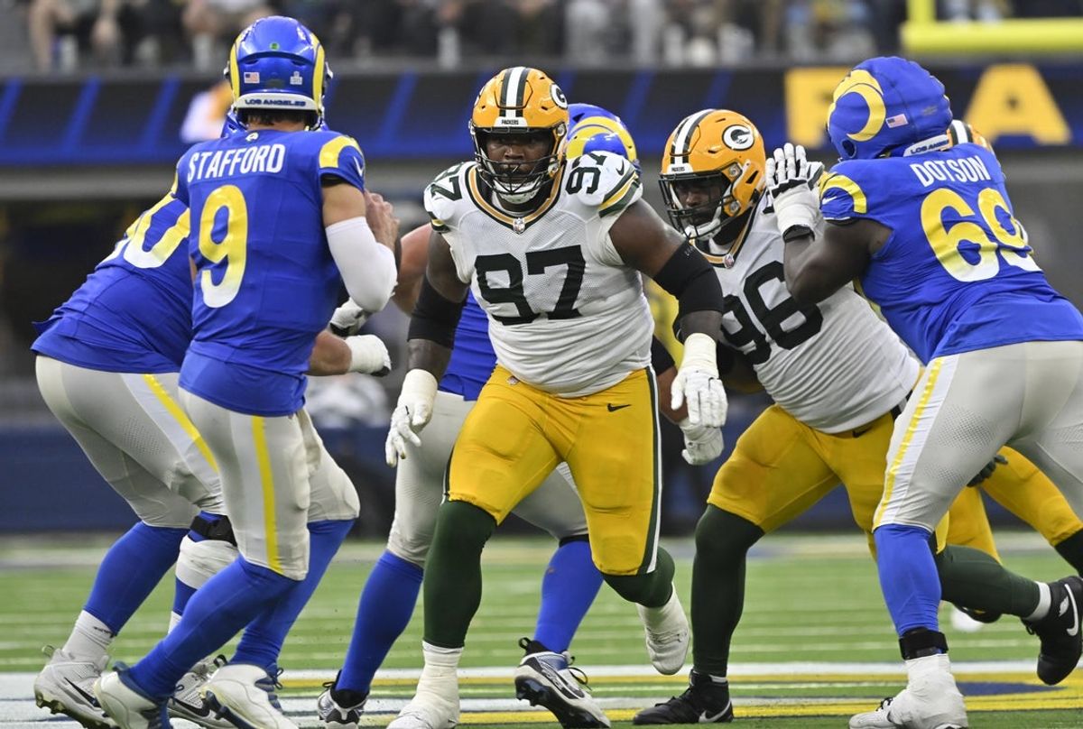 Oct 6, 2024; Inglewood, California, USA; Green Bay Packers defensive tackles Kenny Clark (97) and Colby Wooden (96) pressure Los Angeles Rams quarterback Matthew Stafford (9) during the fourth quarter at SoFi Stadium. Mandatory Credit: Robert Hanashiro-Imagn Images