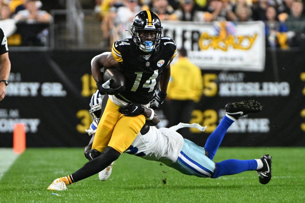 Oct 6, 2024; Pittsburgh, Pennsylvania, USA; Pittsburgh Steelers wide receiver George Pickens (14) breaks a tackle by Dallas Cowboys cornerback Jourdan Lewis (2) during the first quarter at Acrisure Stadium. Mandatory Credit: Barry Reeger-Imagn Images