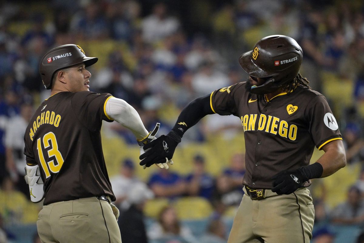 Oct 6, 2024; Los Angeles, California, USA; San Diego Padres outfielder Fernando Tatis Jr. (23) celebrates with third baseman Manny Machado (13) after hitting a two run home run in the ninth inning against the Los Angeles Dodgers during game two of the NLDS for the 2024 MLB Playoffs at Dodger Stadium. Mandatory Credit: Jayne Kamin-Oncea-Imagn Images