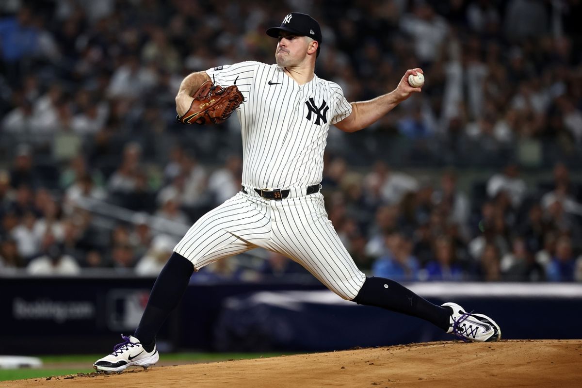 Oct 7, 2024; Bronx, New York, USA; New York Yankees pitcher Carlos Rodon (55) throws a pitch against the Kansas City Royals in the first inning during game two of the ALDS for the 2024 MLB Playoffs at Yankee Stadium. Mandatory Credit: Vincent Carchietta-Imagn Images