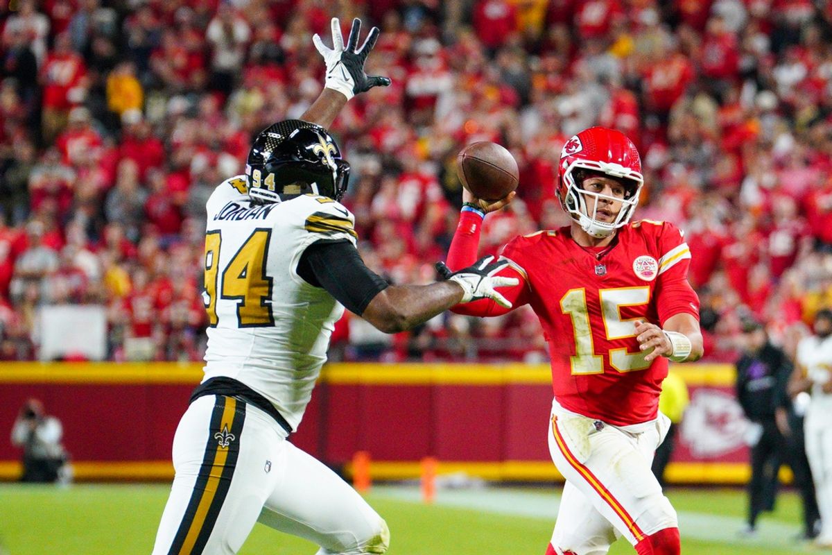 Oct 7, 2024; Kansas City, Missouri, USA; Kansas City Chiefs quarterback Patrick Mahomes (15) throws a pass as New Orleans Saints safety Johnathan Abram (24) defends  during the first half at GEHA Field at Arrowhead Stadium. Mandatory Credit: Denny Medley-Imagn Images