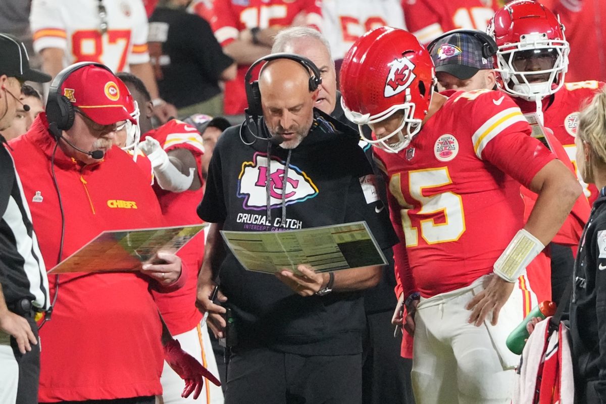 Kansas City Chiefs quarterback Patrick Mahomes (15) looks at plays with offensive coordinator Matt Nagy, center, and head coach Andy Reid against the New Orleans Saints during the first half at GEHA Field at Arrowhead Stadium. Mandatory Credit: Denny Medley-Imagn Images