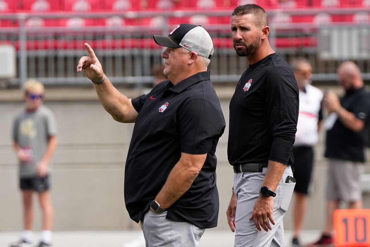 Ohio State Buckeyes offensive coordinator Chip Kelly and co-offensive coordinator Brian Hartline lead warm ups prior to the NCAA football game against the Akron Zips at Ohio Stadium.