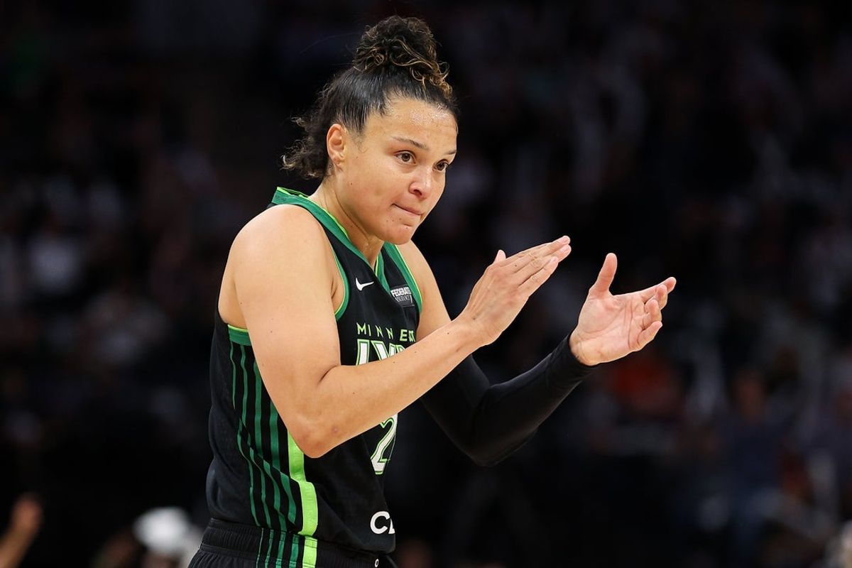 Oct 8, 2024; Minneapolis, Minnesota, USA; Minnesota Lynx guard Kayla McBride (21) celebrates her 3-point basket against the Connecticut Sun during the first half of game five of the 2024 WNBA playoffs at Target Center. Mandatory Credit: Matt Krohn-Imagn Images