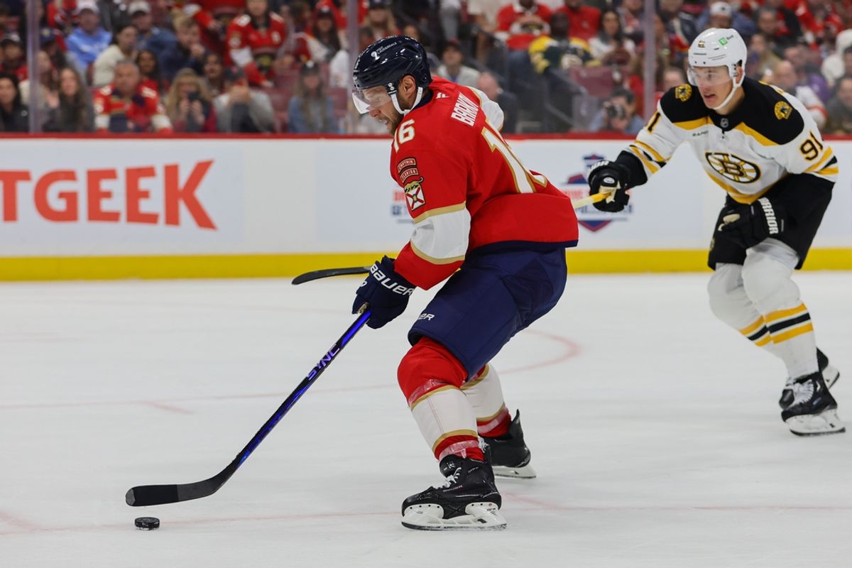 Oct 8, 2024; Sunrise, Florida, USA; Florida Panthers center Aleksander Barkov (16) moves the puck past Boston Bruins defenseman Nikita Zadorov (91) during the second period at Amerant Bank Arena. Mandatory Credit: Sam Navarro-Imagn Images