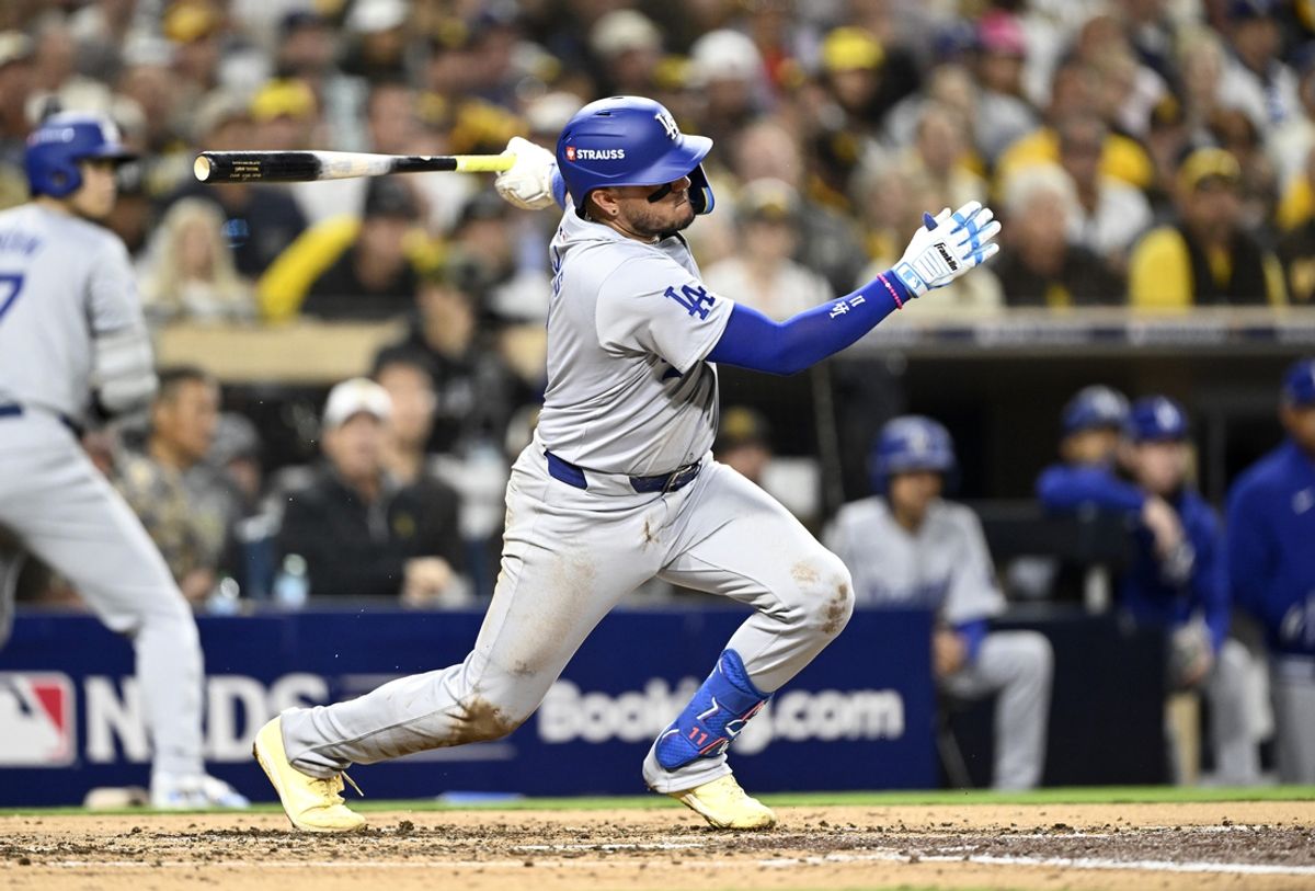 Oct 8, 2024; San Diego, California, USA; Los Angeles Dodgers shortstop Miguel Rojas (11) singles in the third inning against the San Diego Padres during game three of the NLDS for the 2024 MLB Playoffs at Petco Park.  Mandatory Credit: Denis Poroy-Imagn Images