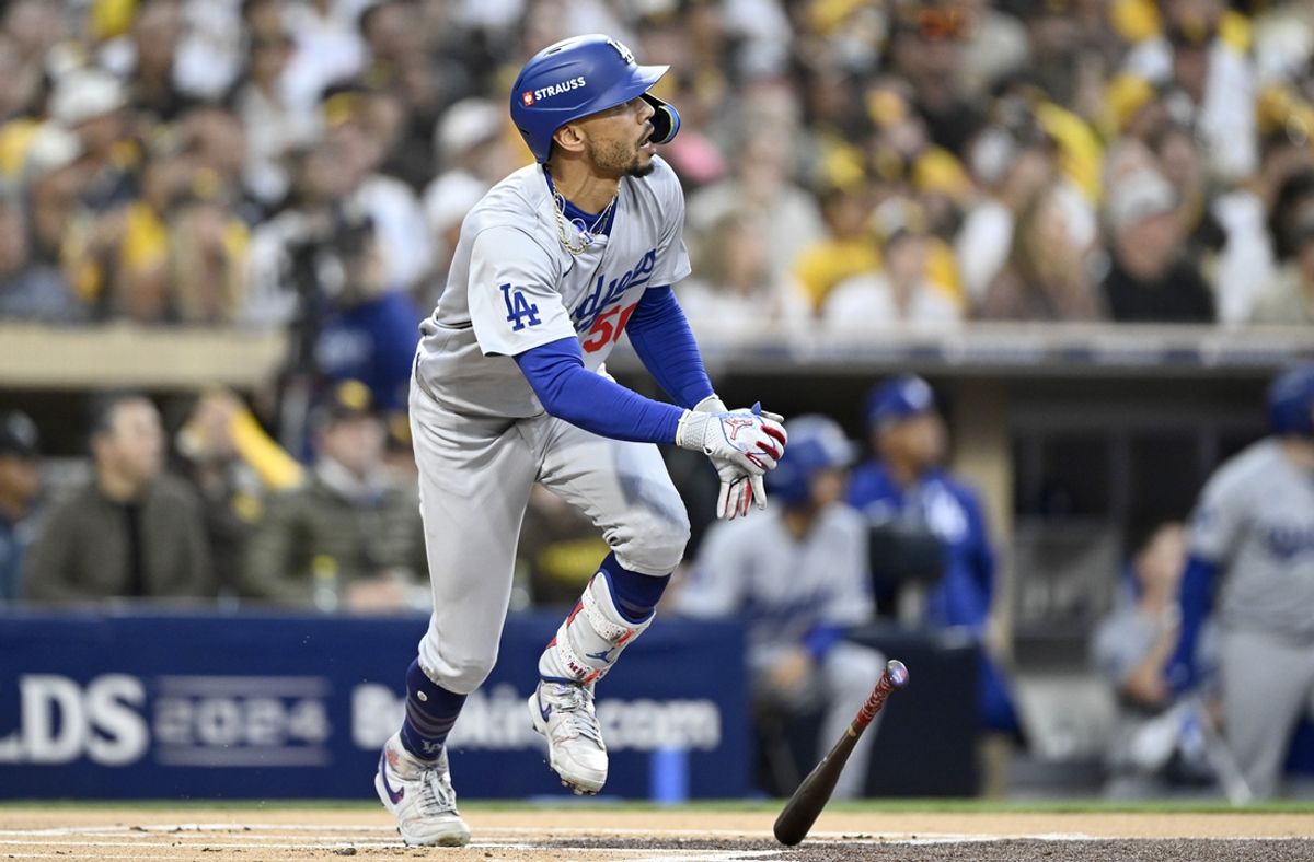 Oct 9, 2024; San Diego, California, USA; Los Angeles Dodgers shortstop Mookie Betts (50) hits a home run in the first inning against the San Diego Padres during game four of the NLDS for the 2024 MLB Playoffs at Petco Park.  Mandatory Credit: Denis Poroy-Imagn Images