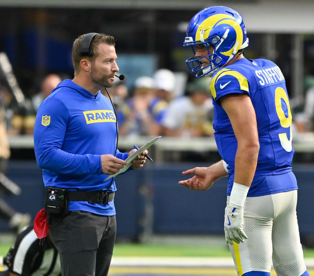 Oct 6, 2024; Inglewood, California, USA; Los Angeles Rams head coach Sean McVay talks to quarterback Matthew Stafford (9) during the third quarter against the Green Bay Packers at SoFi Stadium. Mandatory Credit: Robert Hanashiro-Imagn Images