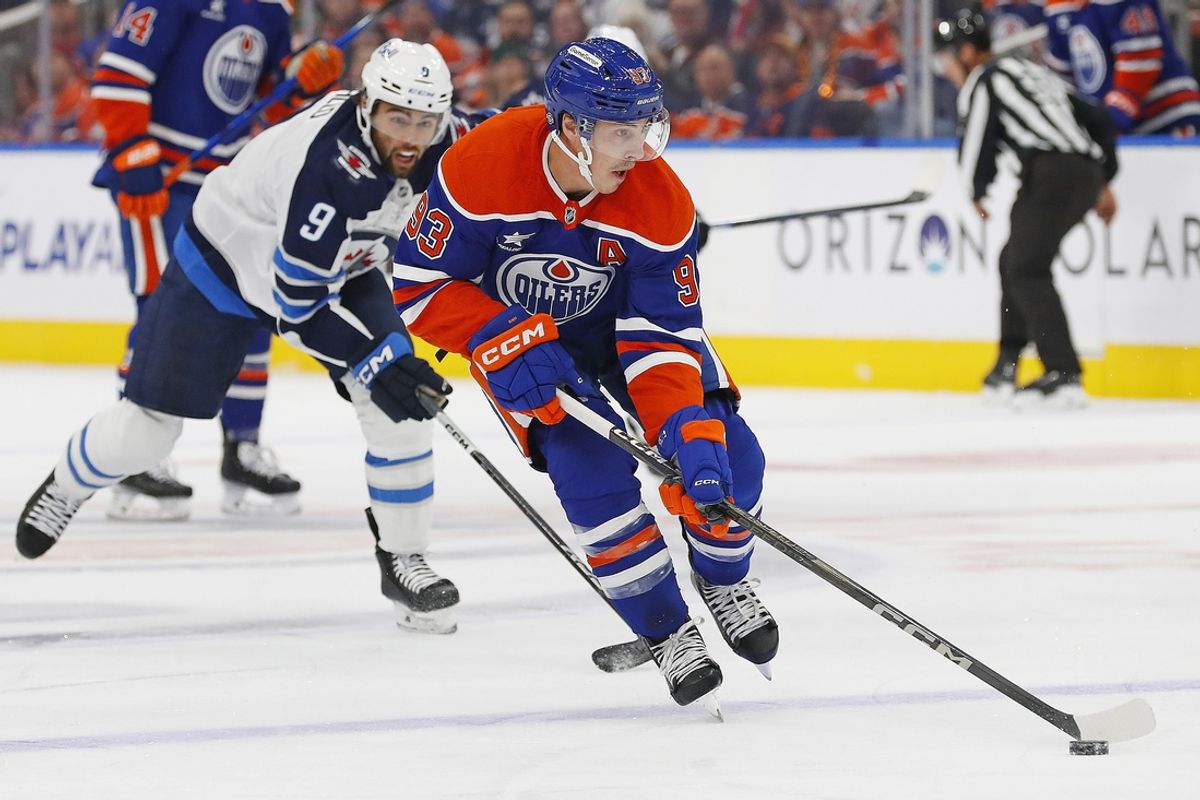 Oct 9, 2024; Edmonton, Alberta, CAN; Edmonton Oilers forward Ryan Nugent-Hopkins (93) looks top make a pass in front of Winnipeg Jets forward Alex Iafallo (9) during the first period at Rogers Place. Mandatory Credit: Perry Nelson-Imagn Images