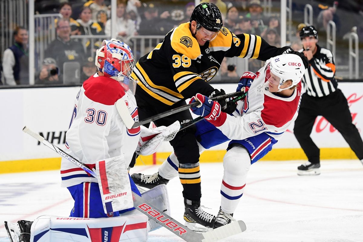 Oct 10, 2024; Boston, Massachusetts, USA; Boston Bruins center Morgan Geekie (39) crosschecks Montreal Canadiens defenseman Kaiden Guhle (21) in front of goaltender Cayden Primeau (30) during the first period at TD Garden. Mandatory Credit: Bob DeChiara-Imagn Images