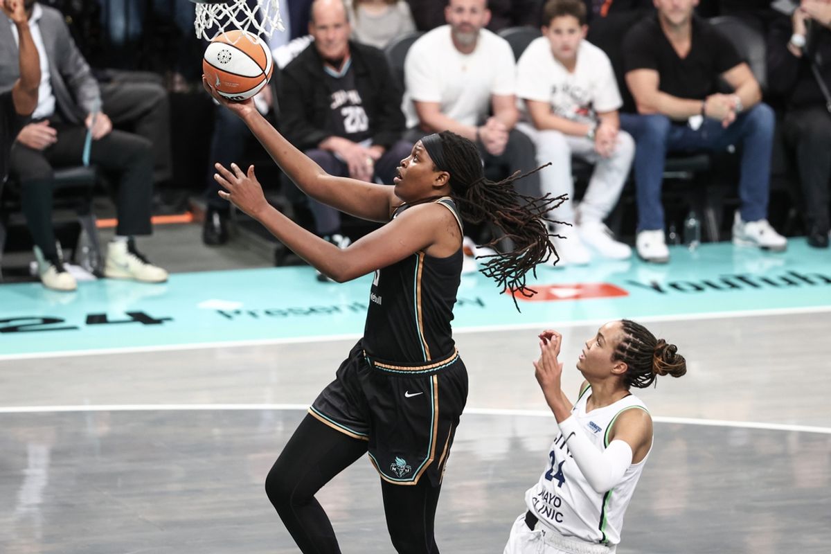 Oct 10, 2024; Brooklyn, New York, USA; New York Liberty forward Jonquel Jones (35) drives past Minnesota Lynx forward Napheesa Collier (24) in the second quarter at Barclays Center. Mandatory Credit: Wendell Cruz-Imagn Images