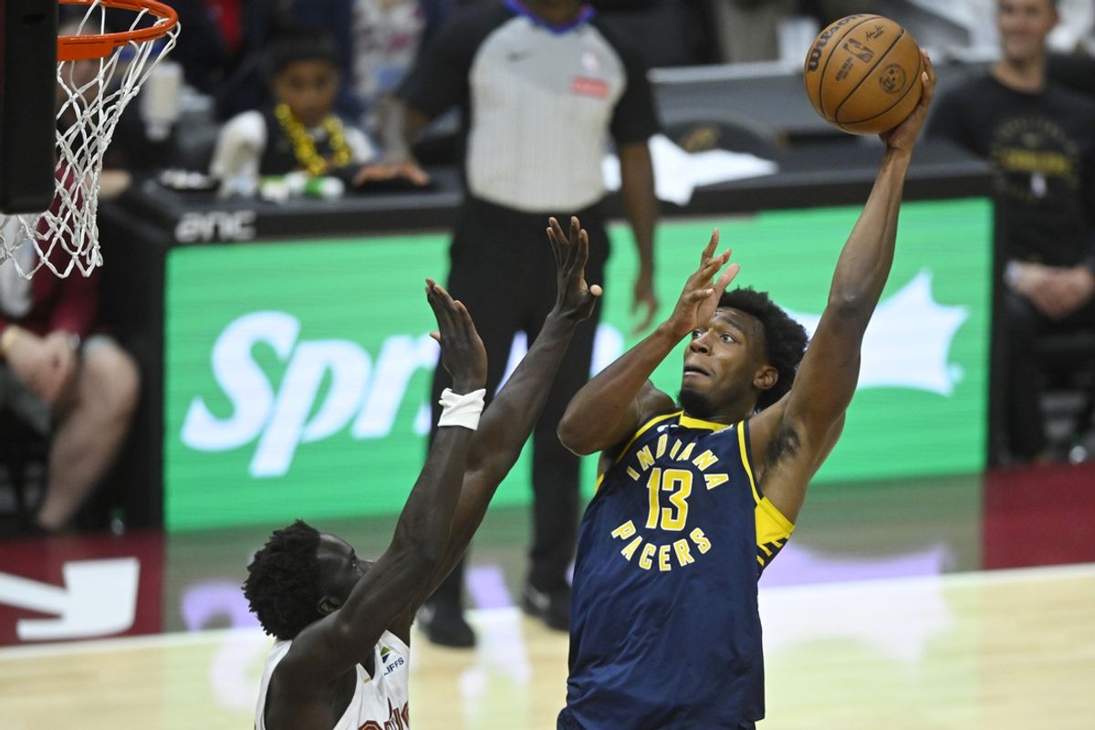 Oct 10, 2024; Cleveland, Ohio, USA; Indiana Pacers center James Wiseman (13) shoots beside Cleveland Cavaliers forward JT Thor (15) in the fourth quarter at Rocket Mortgage FieldHouse. Mandatory Credit: David Richard-Imagn Images
