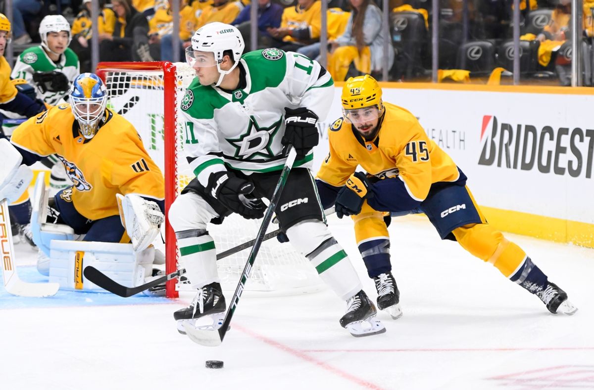 Oct 10, 2024; Nashville, Tennessee, USA; Dallas Stars center Logan Stankoven (11) takes a shot on goal as Nashville Predators defenseman Alexandre Carrier (45) defends during the second period at Bridgestone Arena. Mandatory Credit: Steve Roberts-Imagn Images