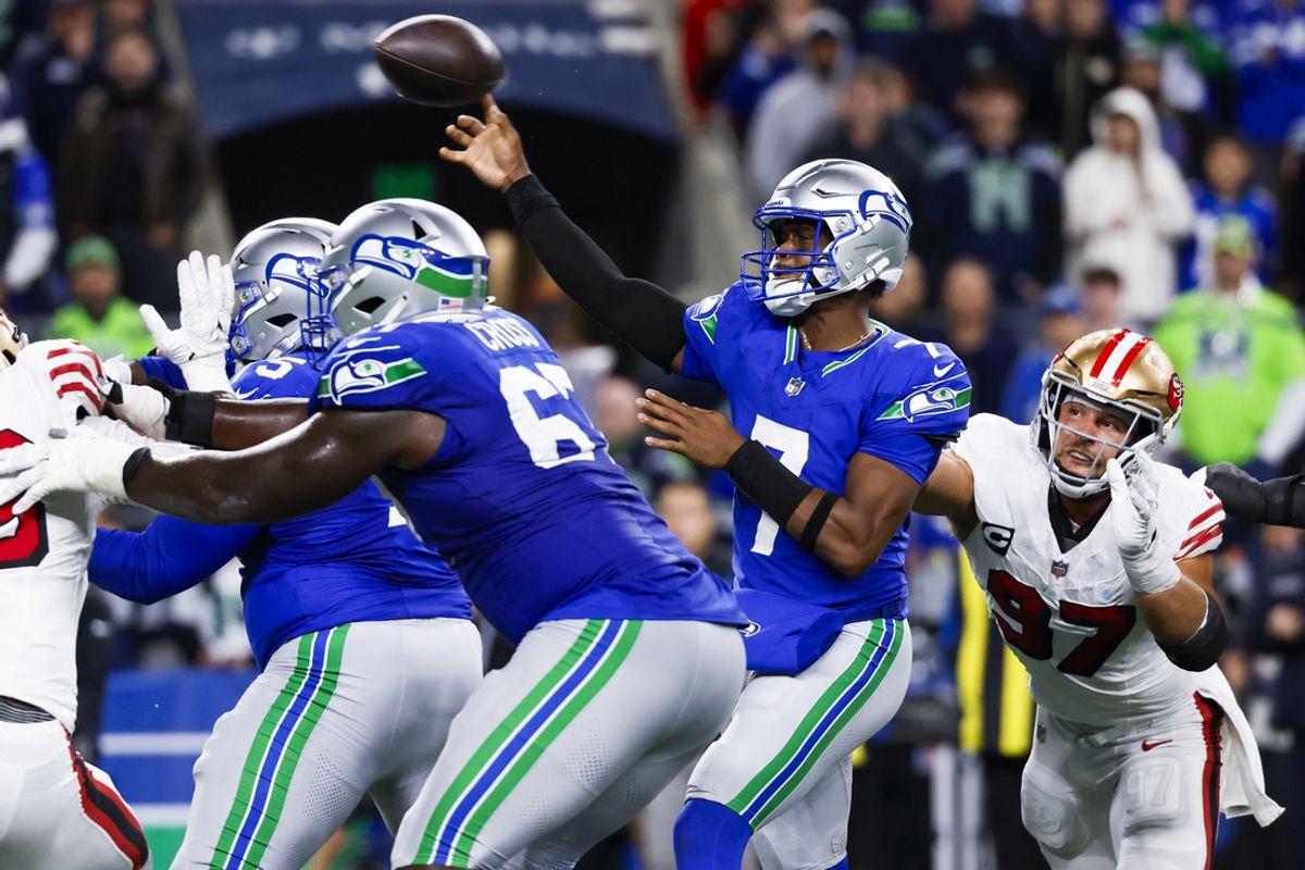 Oct 10, 2024; Seattle, Washington, USA; Seattle Seahawks quarterback Geno Smith (7) passes while under pressure from San Francisco 49ers defensive end Nick Bosa (97) during the fourth quarter at Lumen Field. Mandatory Credit: Joe Nicholson-Imagn Images