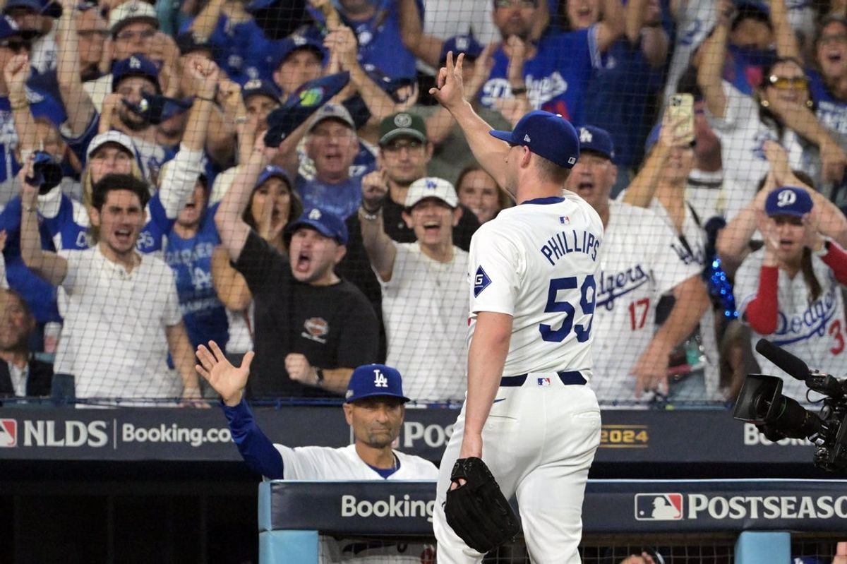 Oct 11, 2024; Los Angeles, California, USA; Los Angeles Dodgers pitcher Evan Phillips (59) reacts after being relieved in the seventh inning against the San Diego Padres during game five of the NLDS for the 2024 MLB Playoffs at Dodger Stadium. Mandatory Credit: Jayne Kamin-Oncea-Imagn Images