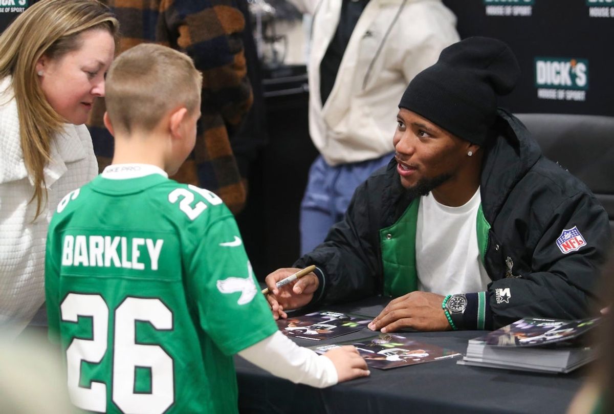 Eagles running back Saquon Barkley speaks with fans at an autograph signing appearance.