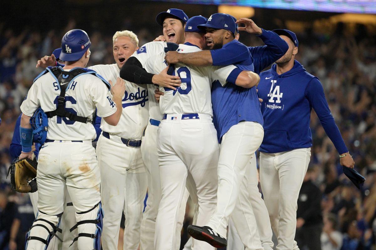 Oct 11, 2024; Los Angeles, California, USA; Los Angeles Dodgers pitcher Blake Treinen (49) and designated hitter Shohei Ohtani (17) and outfielder Teoscar Hernandez (37) celebrate with teammates after defeating the San Diego Padres during game five of the NLDS for the 2024 MLB Playoffs at Dodger Stadium. Mandatory Credit: Jayne Kamin-Oncea-Imagn Images