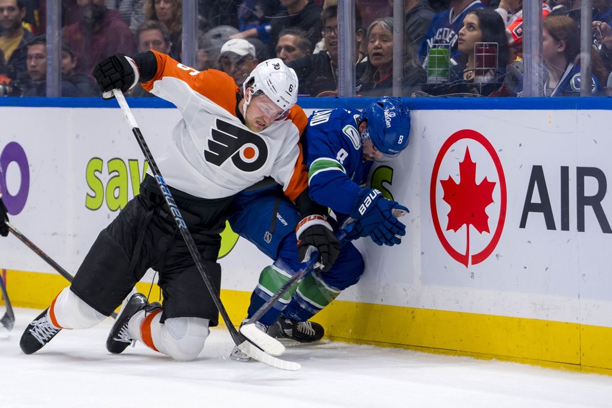 Oct 11, 2024; Vancouver, British Columbia, CAN; Philadelphia Flyers defenseman Travis Sanheim (6) checks Vancouver Canucks forward Conor Garland (8) during the first period at Rogers Arena. Mandatory Credit: Bob Frid-Imagn Images