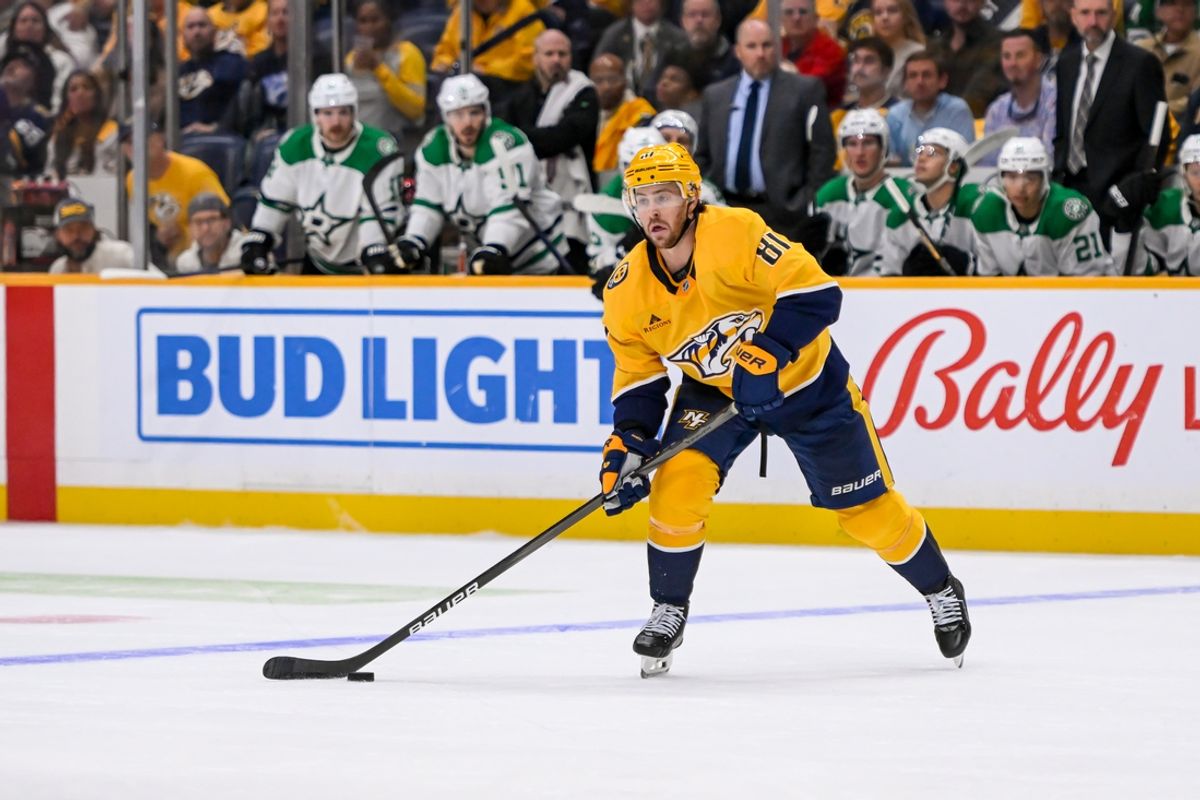 Oct 10, 2024; Nashville, Tennessee, USA;  Nashville Predators center Ryan O'Reilly (90) passes the puck against the Dallas Stars during the third period at Bridgestone Arena. Mandatory Credit: Steve Roberts-Imagn Images