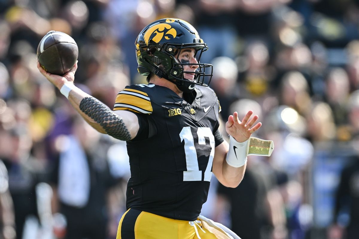 Oct 12, 2024; Iowa City, Iowa, USA; Iowa Hawkeyes quarterback Cade McNamara (12) throws a pass against the Washington Huskies during the first quarter at Kinnick Stadium. Mandatory Credit: Jeffrey Becker-Imagn Images