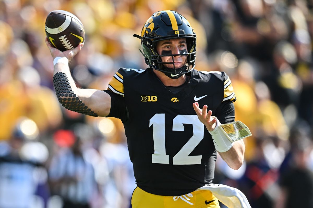 Oct 12, 2024; Iowa City, Iowa, USA; Iowa Hawkeyes quarterback Cade McNamara (12) throws a pass against the Washington Huskies during the first quarter at Kinnick Stadium. Mandatory Credit: Jeffrey Becker-Imagn Images
