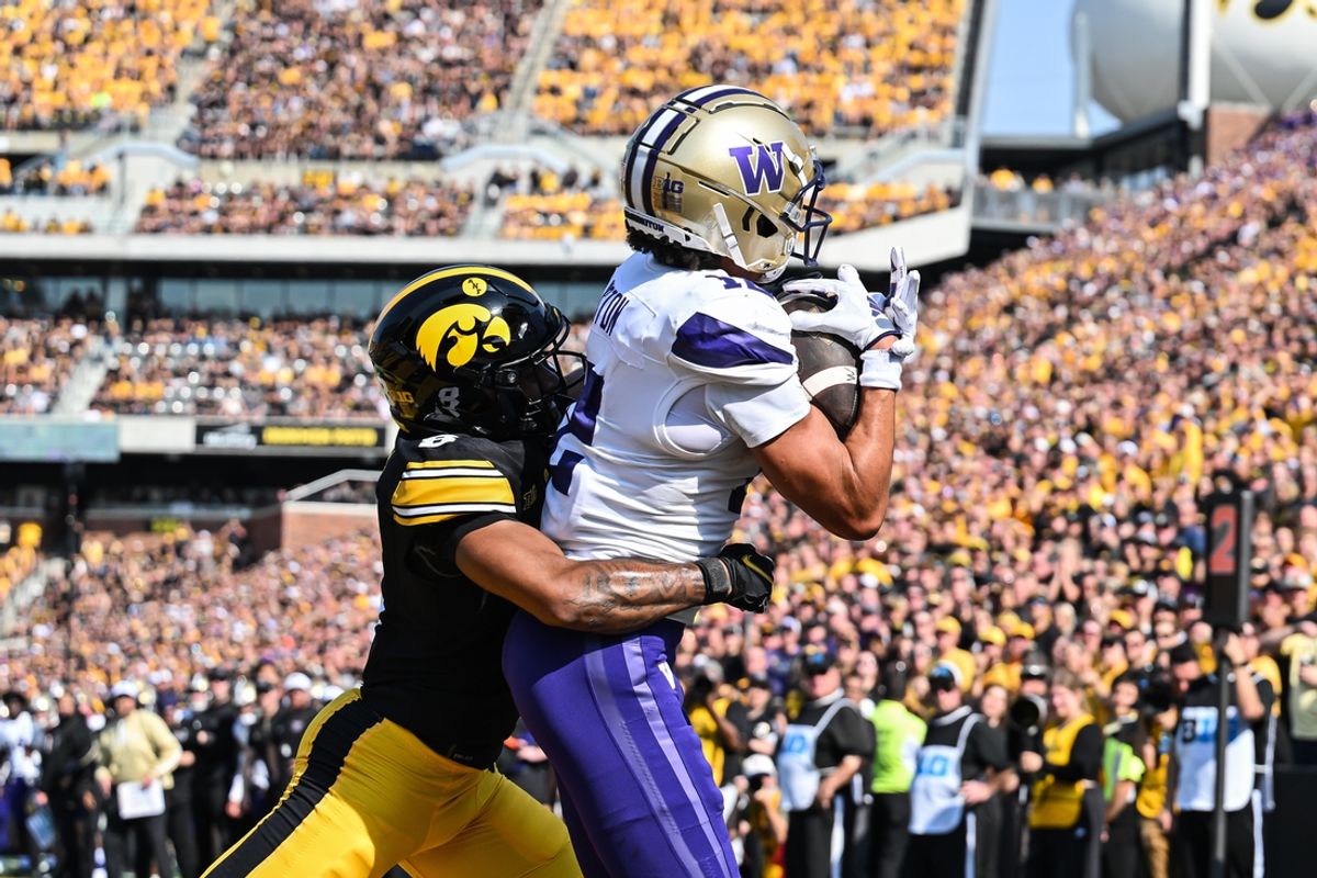 Oct 12, 2024; Iowa City, Iowa, USA; Washington Huskies wide receiver Denzel Boston (12) catches a touchdown pass as Iowa Hawkeyes defensive back Deshaun Lee (8) defends during the second quarter at Kinnick Stadium. Mandatory Credit: Jeffrey Becker-Imagn Images